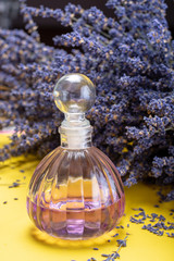 Natural healthy aromatherapy and home fragrance, purple lavender eccential oil in glass decorative bottle and dried lavender flowers