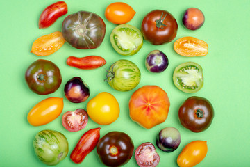 Flat lay top view food background with multicolored assortment of French fresh ripe tomatoes