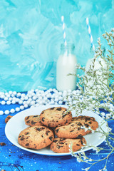 Cookie chocolate with a organic milk bottles near flower