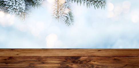 Fir branches at christmas time with wooden table