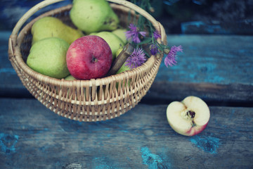 ripe apples in the basket over grass background