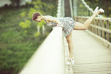 Young adult girl in a short summer dress in a rustic style