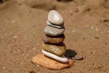 Fototapeta na wymiar Concept: the seven stones in balance, the seven chakras in harmony, the seven senses of human. The concept of balance, harmony, tranquility and purity. Stones are composed from bigger to smaller.