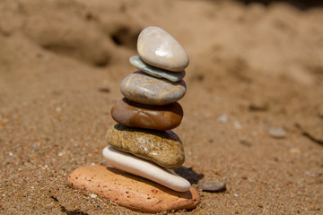 Fototapeta na wymiar Concept: the seven stones in balance, the seven chakras in harmony, the seven senses of man. The concept of balance, harmony, tranquility and purity. Stones on an inclined surface.