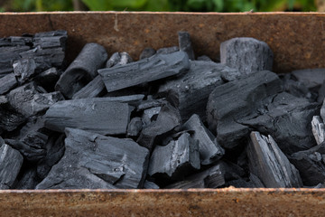 Irregular cooking coals for BBQ ready to be lighted for grilling.