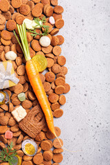 Dutch holiday Sinterklaas background with carrot for Santa's horse, gifts, pepernoten, traditional sweets strooigoed. Flat lay with copy space.