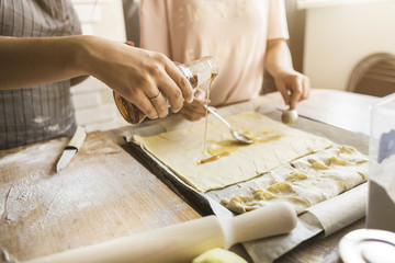 happy family is preparing a pie in the kitchen at home. concept of happy family and home coziness. mother and daughter cooking