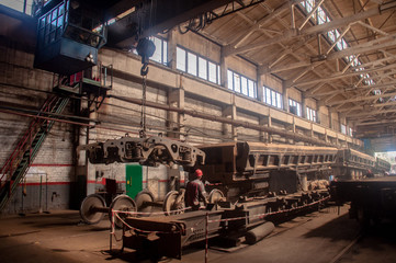 In the workshop for the repair of railway wagons, the wheel carts are assembled by means of a...