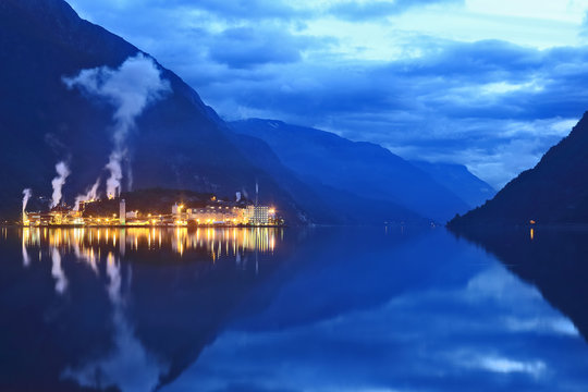 Night city Odda in the reflection of water. Norway