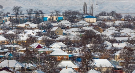 Winter village. Good New Year spirit. Houses in the snow. View from above.