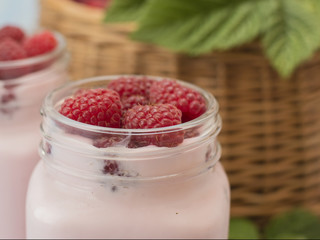 raspberry yogurt on a wooden background. 