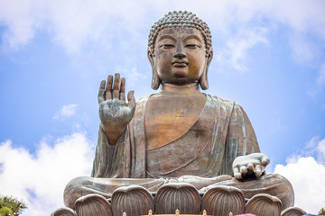 Fototapeta premium Tian Tan Buddha, Big Budda, The enormous Tian Tan Buddha at Po Lin Monastery in Hong Kong. The world's tallest outdoor seated bronze Buddha located in Nong ping 360.