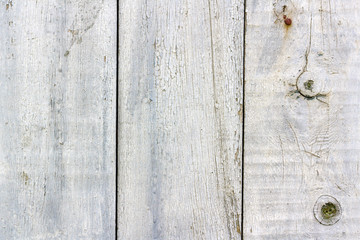 White painted weathered old wooden boards texture with scuffs and cracks closeup. Abstract wooden...