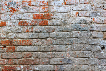 Texture of vintage red brick wall with cement mortar and dirty stains. Abstract brick wall background
