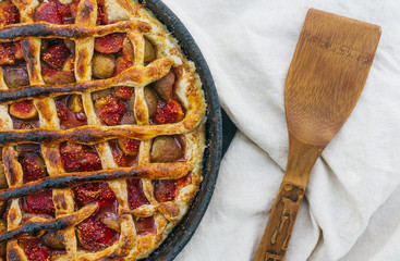 Autumn fig pie or tart with cinnamon on an old wooden table. Top view
