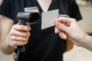 Hand scanning barcode on member card with credit card reader