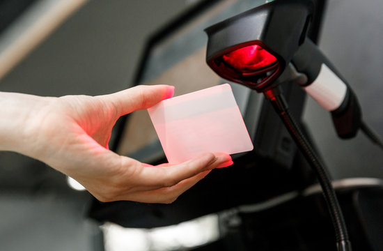 Hand Scanning Barcode On A Card On The Counter