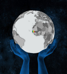 Senegal on globe in hands