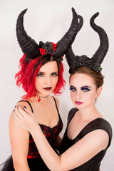 two girls with horns on head posing in front of camera