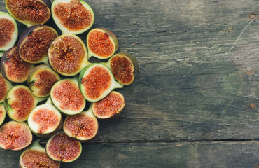 Fresh red figs background on an old wooden table. Top view. Close up