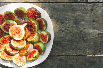 Some fresh red figs in a wooden bowl. Top view. Close up
