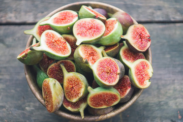 Some fresh red figs in a wooden bowl. Top view. Close up