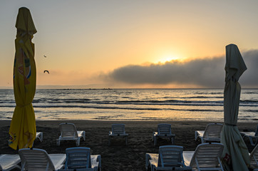 Sunbeds on the beach of Black Sea at sunrise, warm moments