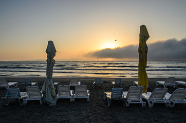 Sunbeds on the beach of Black Sea at sunrise, warm moments