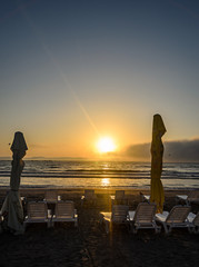 Sunbeds on the beach of Black Sea at sunrise, warm moments