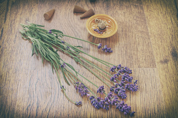 Lavender flowers and incense aroma cones on a wooden table. Vintage style.