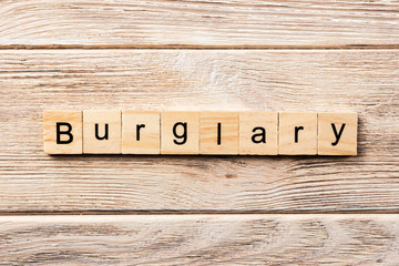 burglary word written on wood block. burglary text on table, concept