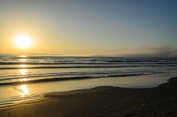 Fototapeta na wymiar Beach of Black Sea from Mamaia, Romania at sunrise , warm sunshine atmosphere