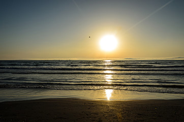 Beach of Black Sea from Mamaia, Romania at sunrise , warm sunshine atmosphere