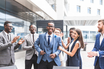 Portrait of an handsome businessman in front of his team. recognition, movement on the career ladder, success in business