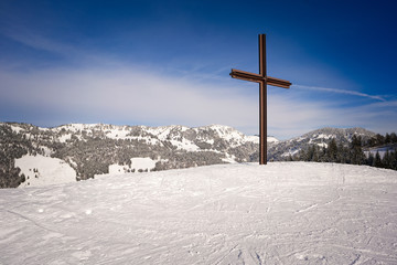 Steely summit cross on a bare hilltop