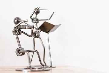 Figures of music performers made with welded black metal wire, .violinist and conductor are playing...