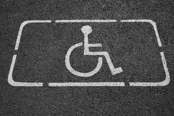Disability Symbol photos on asphalt