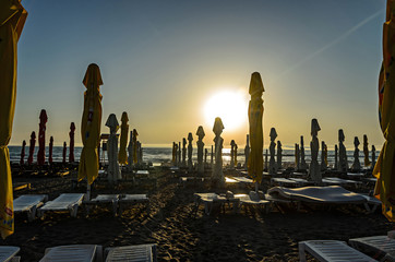 MAMAIA, ROMANIA - SEPTEMBER 15, 2017: Beach of Black Sea with sunbeds and umbrellas, blue clear...