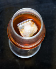 Liquor glass with ice cube