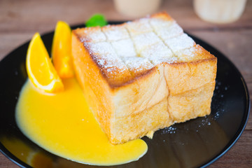 Honey toast served with orange slice