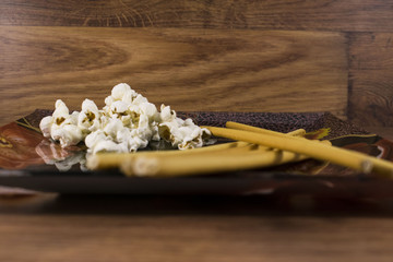 white popcorn chopsticks on plate