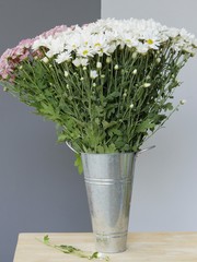 bouquet of beautiful blooming white chrysanthemum flowers with green leaves