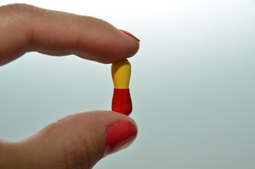 capsule for treatment, a beautiful capsule in the hands of a girl for losing weight