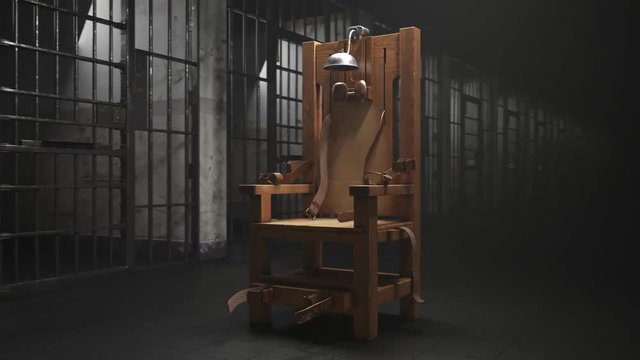 Wooden electric chair in the spotlight in a prison block. Vertigo shot. 4K HD