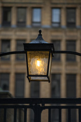 Street Lamp with a tall building on the background