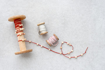 Old wooden spools with cotton ribbons for handicraft.