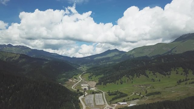 Green mountain covered by cloudy sky. Top view of green high mountains