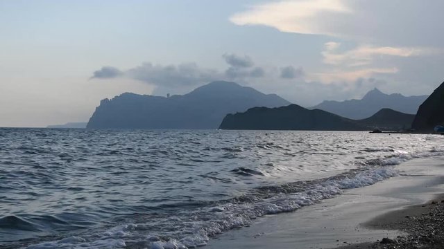 Evening seascape with beach and mountains