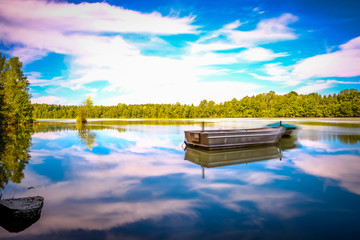 Reflection in water of mountain lakes and boats.