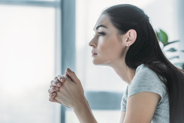 side view of beautiful upset brunette girl looking away